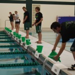 Team members from the Boys and Girls Swim Teams participate in the "Pouring of Waters"