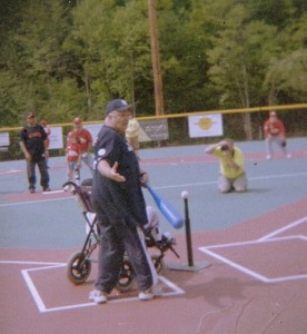 Jamie Adams prepares to bat with the help of her father and CRML founder Burke Adams on opening day. In the background in black shirt is Hall of Famer Orlando Cepeda, who threw out the first pitch. 