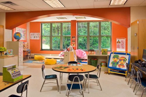 The colorful kindergarten rooms, featuring a prominent arch setting the stage for group reading and creative play, were key to Mosaic Associates Architects Shatekon Elementary School design.